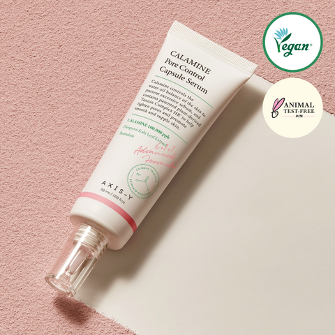 Calamine Pore Control Capsule Serum bottle on a pink background with vegan and animal test-free logos.