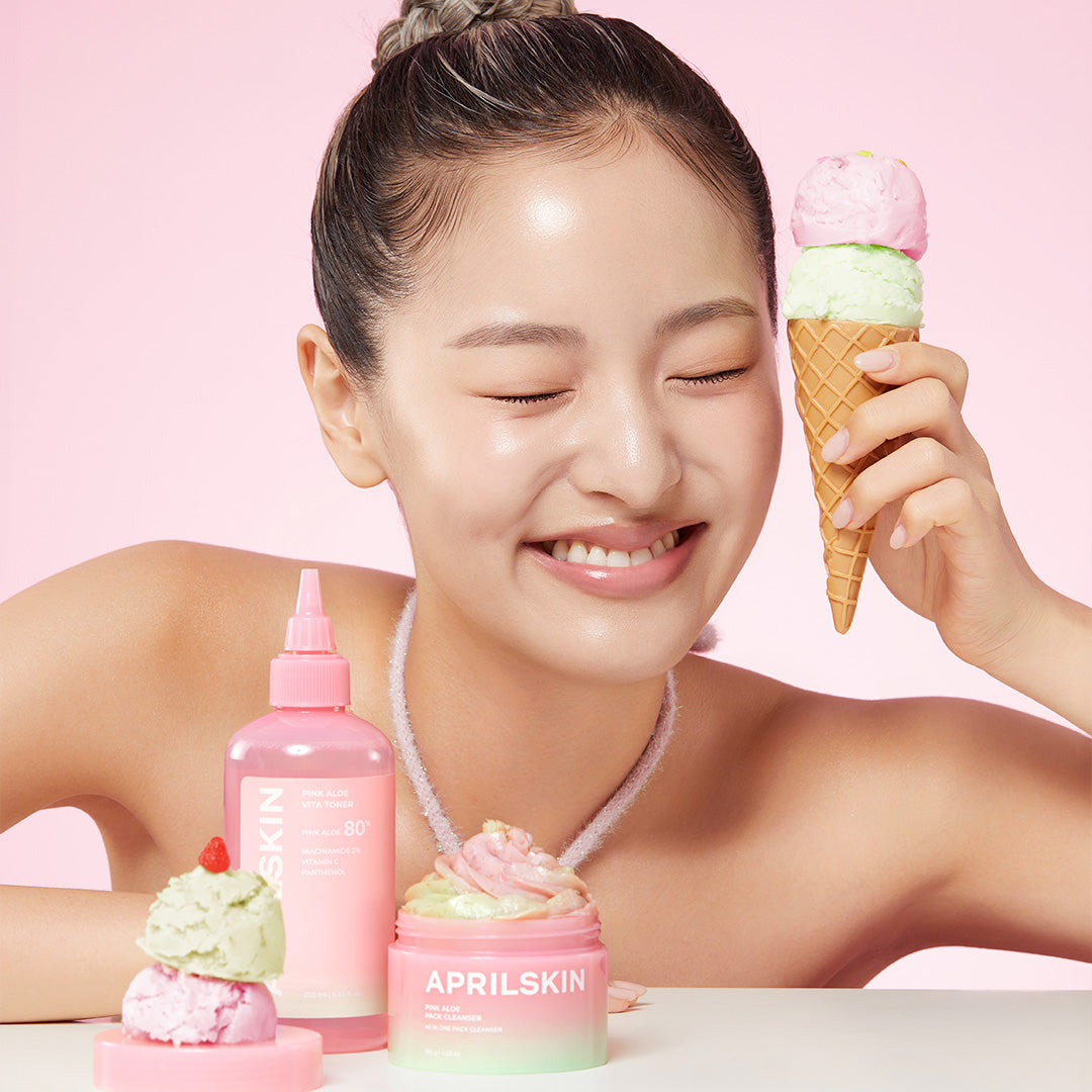 Woman holding an ice cream cone with skincare products on a pink background