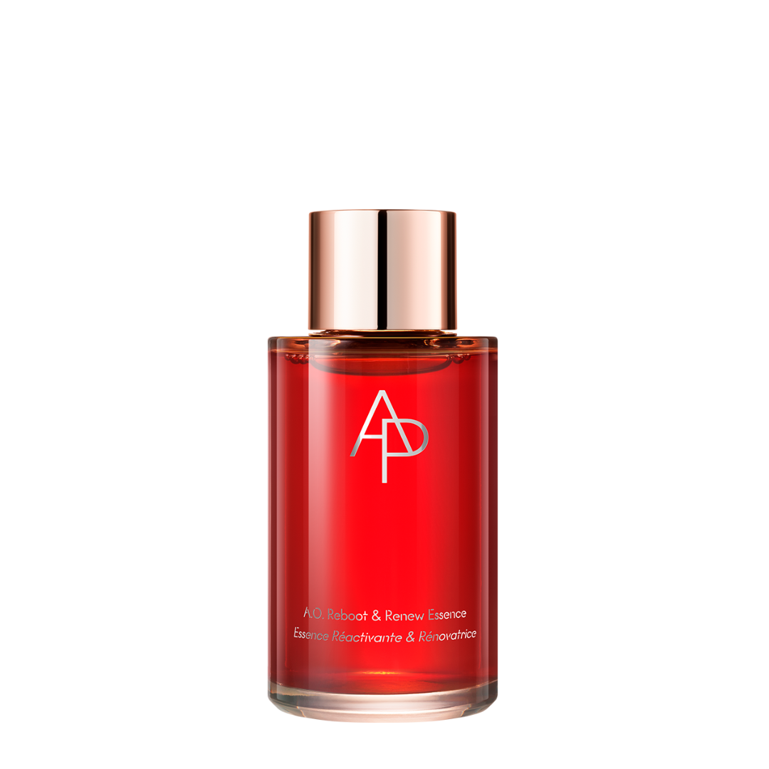 Red bottle with a rose gold cap on a white background