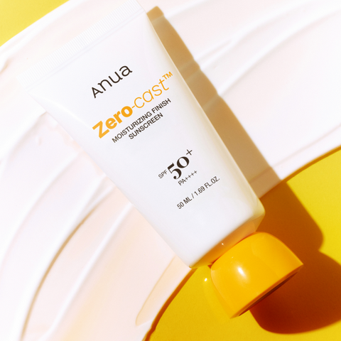 Anua Zero Cast sunscreen bottle on a yellow background