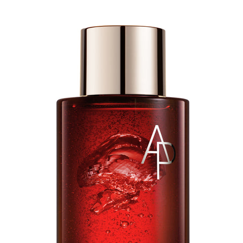 Red skincare bottle with silver cap on a white background