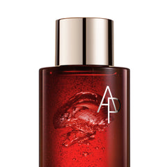 Red skincare bottle with silver cap on a white background