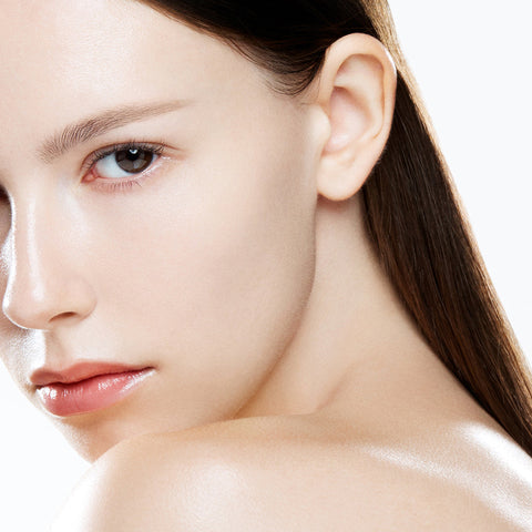 Close-up of a woman's face with smooth skin on a white background