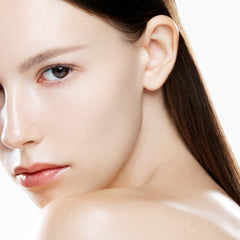 Close-up of a woman's face with smooth skin on a white background