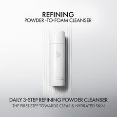 White bottle of refining powder-to-foam cleanser on a light gray background with text about its benefits.