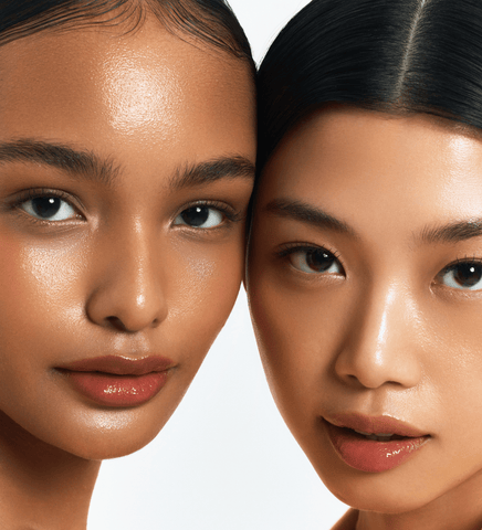 Close-up of two women's faces with a neutral background