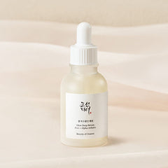 Skincare serum bottle with dropper on a beige background