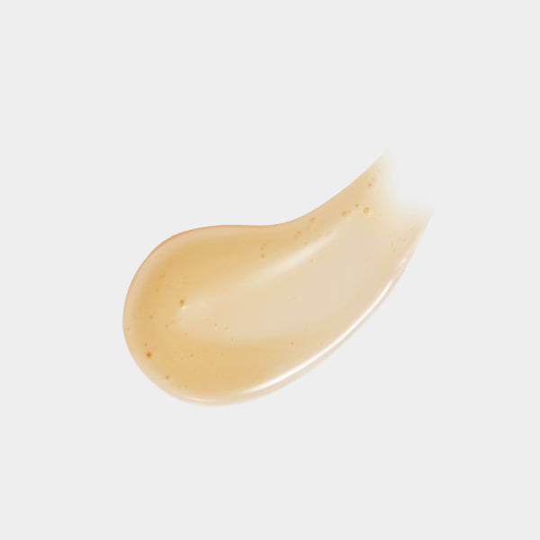 Close-up of a beige cream swatch on a light gray background