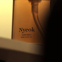 Nyeok hand wash bottle with label in a warm glow