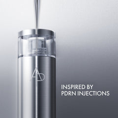 Silver skincare serum bottle with 'AD' logo on a gray background