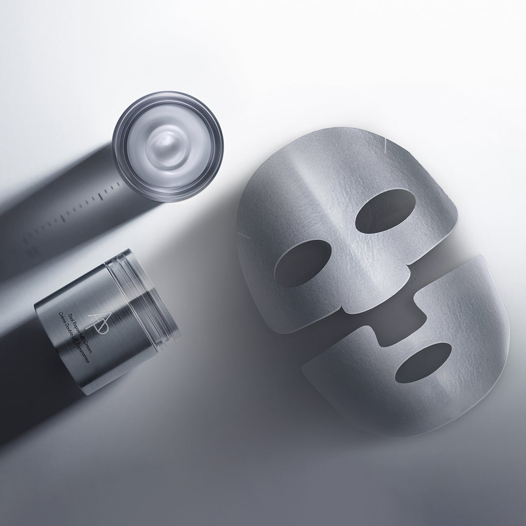 Skincare products including a mask, bottle, and jar on a light gray background