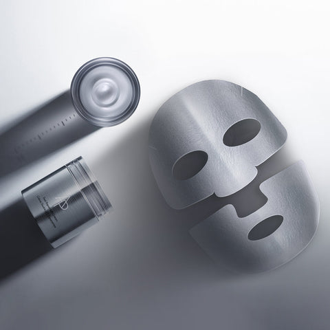 Skincare products including a mask, bottle, and jar on a light gray background