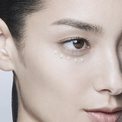 Close-up of a woman's face with a focus on her eye and cheek area.