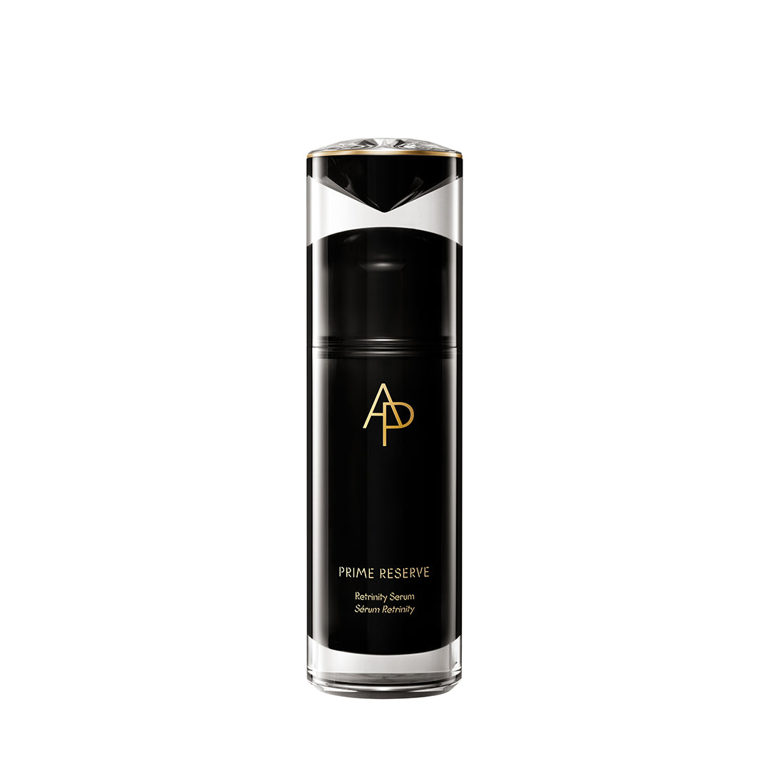 Black skincare serum bottle with gold logo on a white background