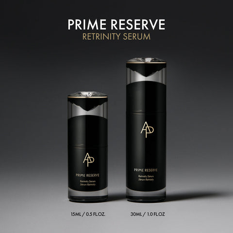 Two black bottles of Prime Reserve Retrinity Serum on a gray background