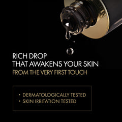 Gold bottle with black dropper on a black background, featuring text about skin care product.