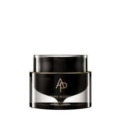 Black and gold jar of skincare product on a white background