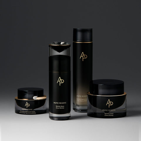 Set of black skincare products with gold accents on a gradient background