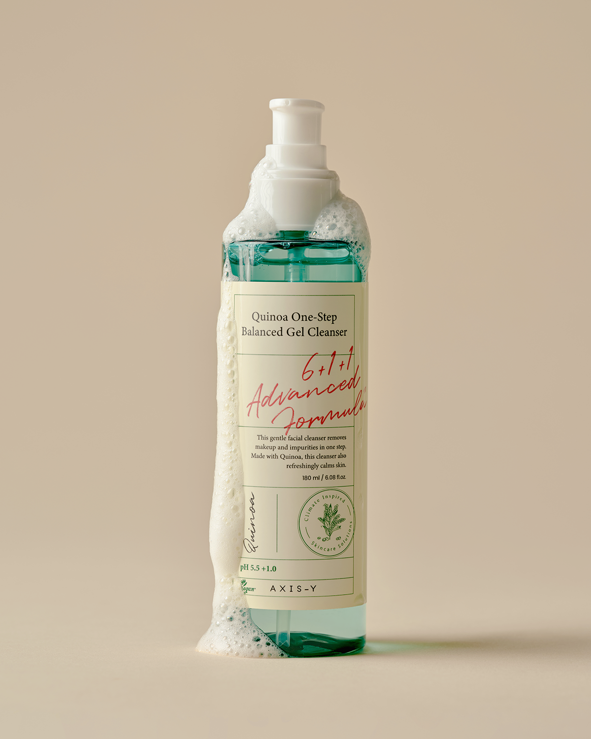 Bottle of Quinua One Step Balanced Gel Cleanser with a beige label on a beige background