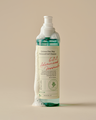 Bottle of Quinua One Step Balanced Gel Cleanser with a beige label on a beige background