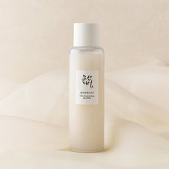 Skincare bottle with a label on a beige background