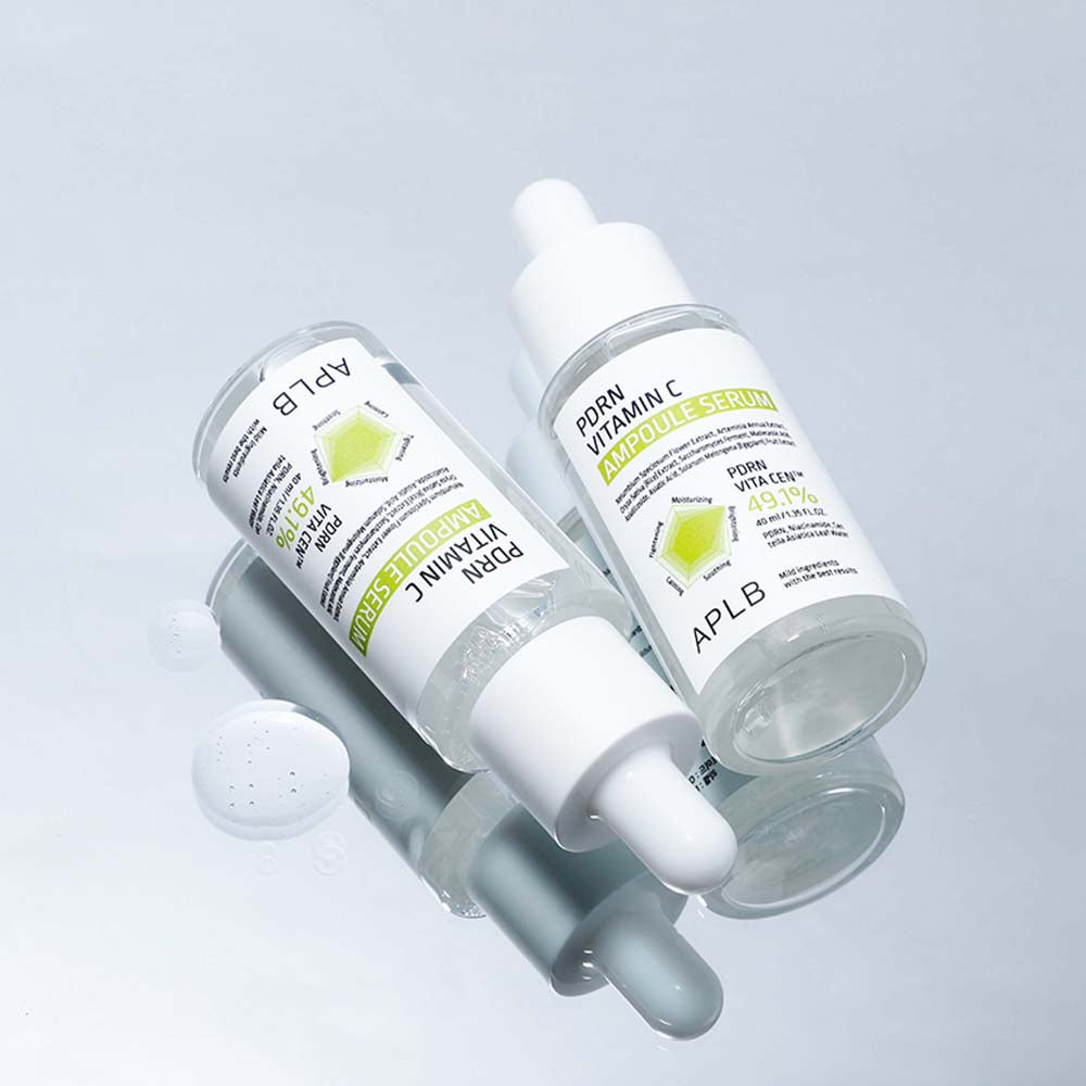 Two skincare droppers with visible branding on a light gray background