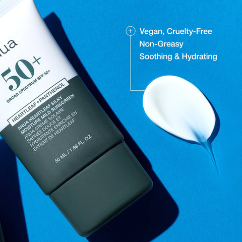Sunscreen bottle with a droplet of cream on a blue background, featuring text about product attributes.