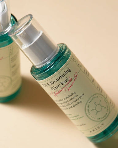 Skincare product bottle with text on a beige background