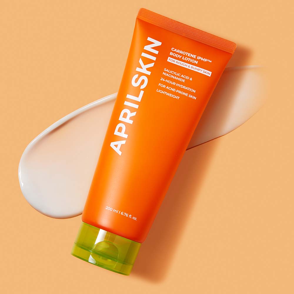 Orange APRILSKIN body lotion tube on a beige background