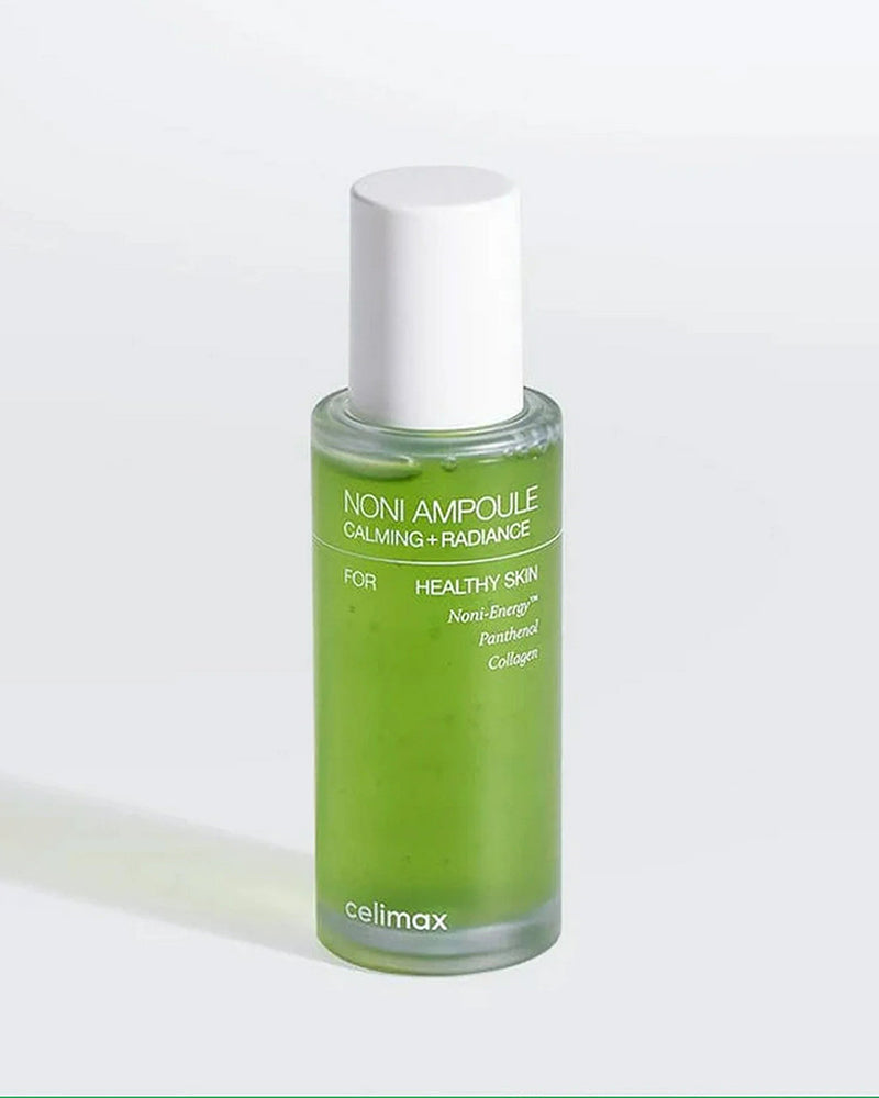 Green bottle of Celimax Noni Ampoule on a white background