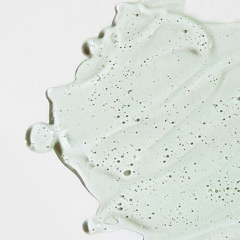 Close-up of a light gray concrete surface with speckles on a white background