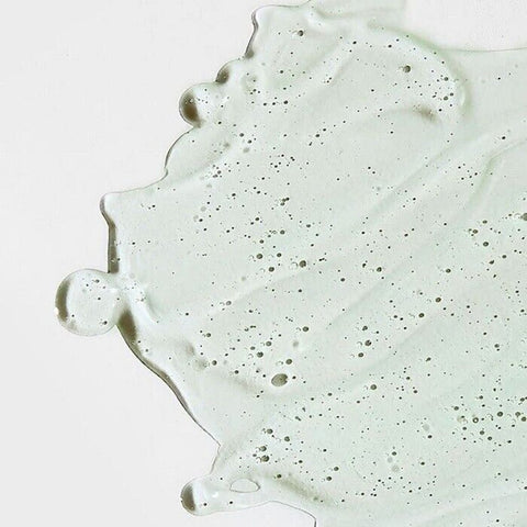 Close-up of a light gray concrete surface with speckles on a white background