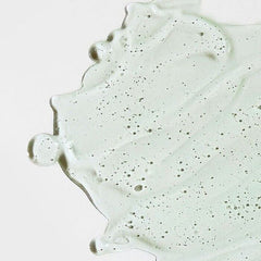 Close-up of a light gray concrete surface with speckles on a white background
