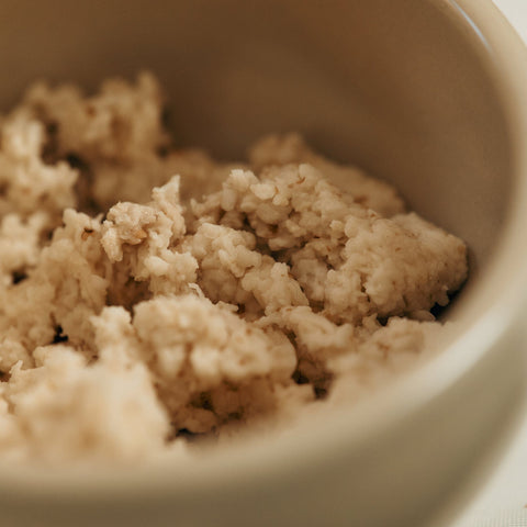 Close-up of crumbled beige substance in a bowl