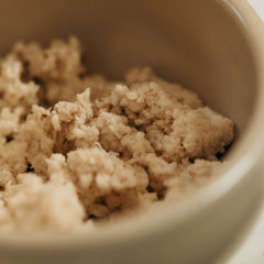 Close-up of crumbled beige substance in a bowl
