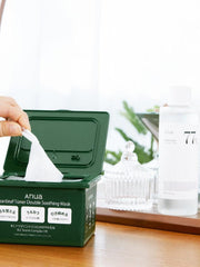 Green box of Anua heartleaf toner double soothing mask with a hand pulling out a sheet mask.