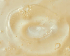 Close-up of a beige cream with visible texture and droplets