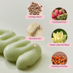 Green soap bar with circular insets showing ingredients like centiger bean, cochineal fruit, rice bran oil, coptis japonica root, and gardenia florida on a light gray background.