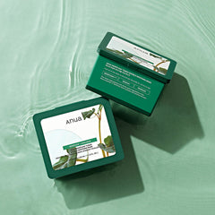 Two green boxes with product labels on a green background