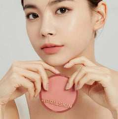 Woman holding a pink compact with 'APRILSKIN' branding against a neutral background
