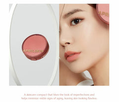 APRILSKIN skincare compact with a close-up of a person's face, highlighting the product.