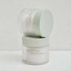 Two skincare containers with labels on a light gray background