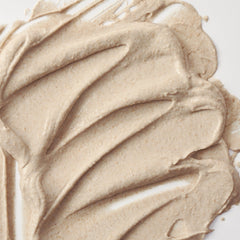Close-up of beige cream swatch on a white background